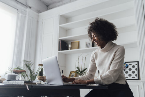 Mid adult woman working in her home office, using laptop - BOYF00901