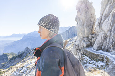 Germany, Garmisch-Partenkirchen, Alpspitze, Osterfelderkopf, female hiker on viewpoint looking at view - TCF05925