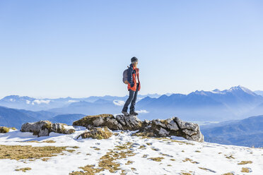 Germany, Garmisch-Partenkirchen, Alpspitze, Osterfelderkopf, female hiker on viewpoint looking at view - TCF05928