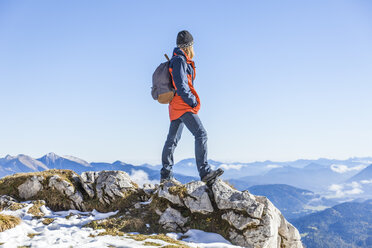 Germany, Garmisch-Partenkirchen, Alpspitze, Osterfelderkopf, female hiker on viewpoint looking at view - TCF05930