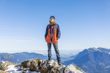 Germany, Garmisch-Partenkirchen, Alpspitze, Osterfelderkopf, female hiker on viewpoint looking at view - TCF05932