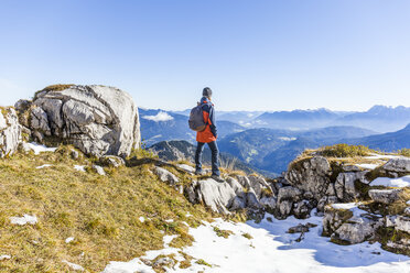Germany, Garmisch-Partenkirchen, Alpspitze, Osterfelderkopf, female hiker on viewpoint looking at view - TCF05933