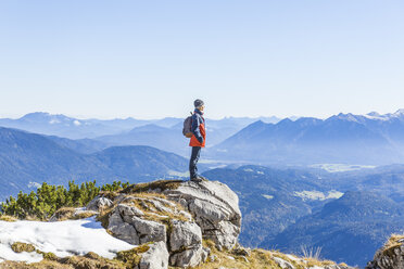 Germany, Garmisch-Partenkirchen, Alpspitze, Osterfelderkopf, female hiker on viewpoint looking at view - TCF05935