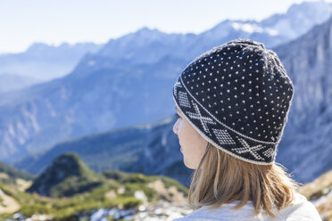 Germany, Garmisch-Partenkirchen, Alpspitze, Osterfelderkopf, female hiker on viewpoint looking at view - TCF05937