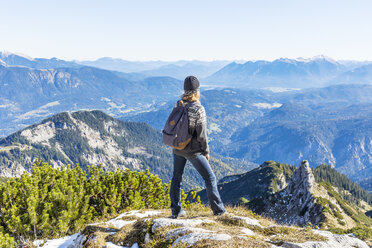 Germany, Garmisch-Partenkirchen, Alpspitze, Osterfelderkopf, female hiker on viewpoint looking at view - TCF05942