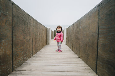 Baby girl walking on a wooden walkway - GEMF02504