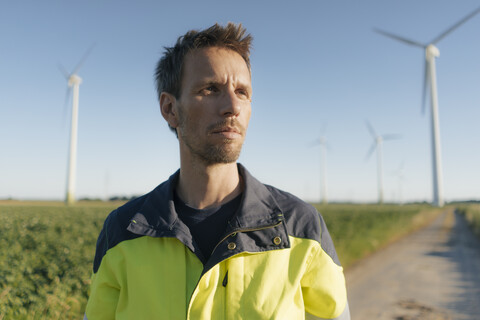 Portrait of an engineer on field path at a wind farm stock photo