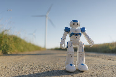 Robot standing on field path at a wind farm - GUSF01324