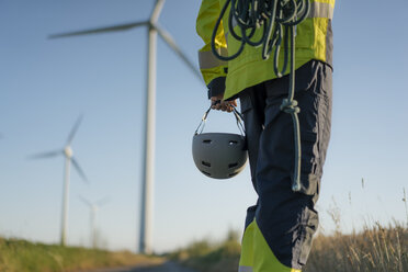 Close-up of technician at a wind farm with climbing equipment - GUSF01326