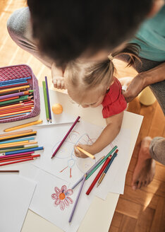 Kleines Mädchen malt mit Buntstift, während ihr Vater sie beobachtet, Ansicht von oben - ZEDF01756