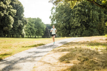 Young woman running in a park - MOEF01544