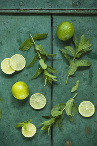Mint and limes on rustic wooden background stock photo