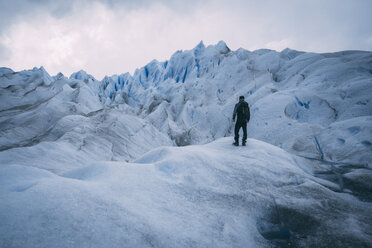 Full length of hiker standing on glacier - CAVF54164