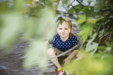 High angle portrait of girl sitting in lake - CAVF54299