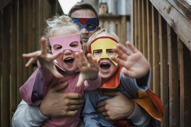Portrait of children with father in superhero costumes - CAVF54310