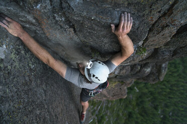 High angle view of male hiker rock climbing - CAVF54322