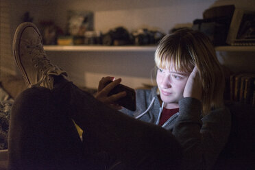 Teenage girl using smart phone at home - CAVF54327