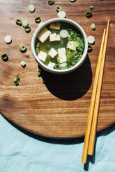 High angle view of soup bowl with chopsticks on serving board in commercial kitchen - CAVF54437