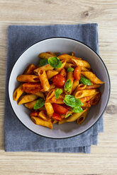Penne with tomato and basil in bowl from above - GIOF04820