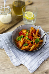 Penne with tomato and basil in bowl - GIOF04822