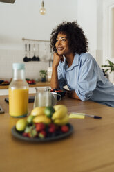 Woman having a healthy breakfast in her kitchen - BOYF01064