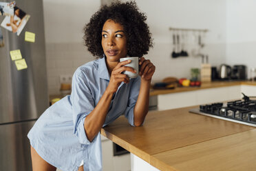 Woman standng in her kitchen, having her morning coffee - BOYF01067