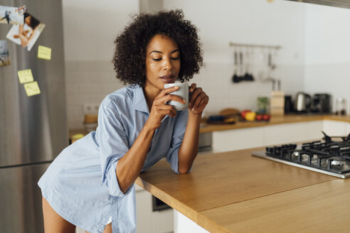 Woman standng in her kitchen, having her morning coffee - BOYF01068
