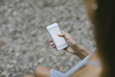 Woman using smartphone, partial view - MOMF00544