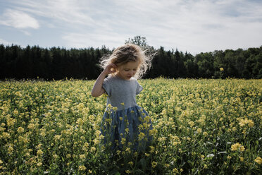 Cute girl standing amidst plants against sky - CAVF54672