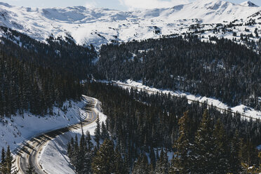 High angle view of road amidst trees on mountain during winter - CAVF54890