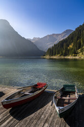 Austria, Tyrol, Allgaeu Alps, Tannheim Mountains, View of boats on lake Vilsalpsee - STSF01805