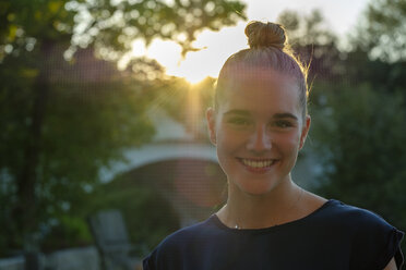 Portrait of young woman with bun at backlight - LBF02222