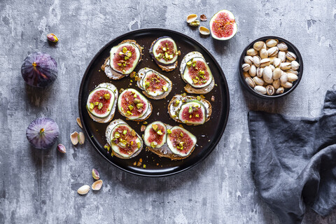 Bread with goat cheese, figs and pistachio stock photo