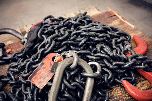 Close-up of chain and hooks at metal industry - CAVF54967