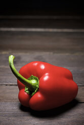 Close-up of red bell pepper on wooden table - CAVF55047