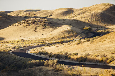 High angle view of off-road vehicle on country road amidst field - CAVF55203