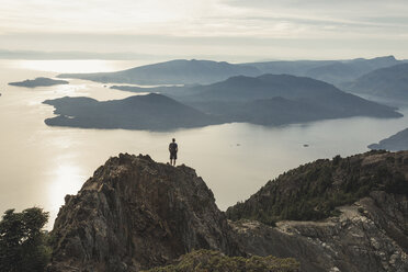 High angle view of carefree hiker standing on mountain against sky during sunset - CAVF55265