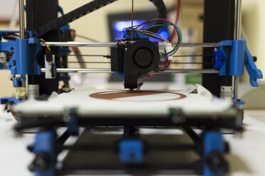 Close-up of 3D printer on table at office - CAVF55531