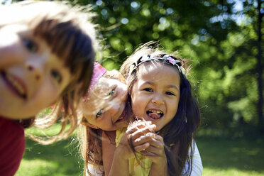 Portrait of cheerful girls during birthday celebration at park - CAVF55848