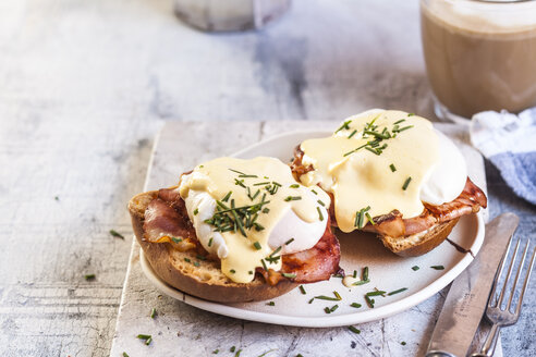 Traditional egg benedict with slices of bacon on toast, poached egg and hollandaise - SBDF03827