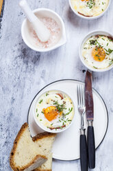 Oefs en cocotte (Individual baked eggs) with spinach, feta, bacon, eggs, and slices of bread - SBDF03832