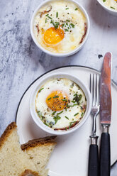 Oefs en cocotte (Individual baked eggs) with spinach, feta, bacon, eggs, and slices of bread - SBDF03833
