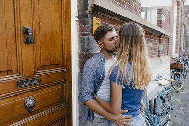 Zärtliches junges Paar, das sich in der Stadt küsst - GUSF01500