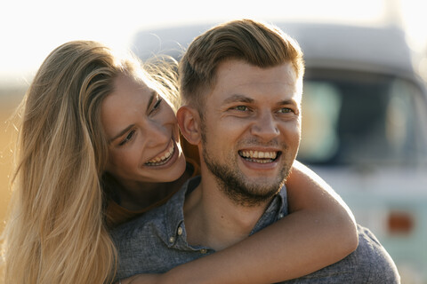 Happy affectionate young couple at camper van stock photo