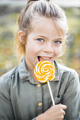 Portrait of girl licking lollipop - HMEF00085