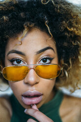 Portrait of young woman wearing yellow sunglasses - JCMF00007