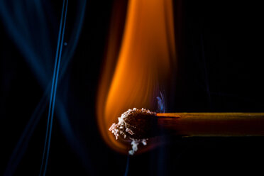 Burning matchsticks against black background, close up stock photo