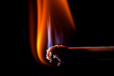 Burning matchsticks against black background, close up stock photo