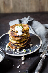 Stack of zucchini fritters with garlic yogurt sauce and feta - SBDF03860