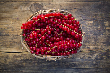 Rote Johannisbeeren im Korb auf Holz - LVF07561